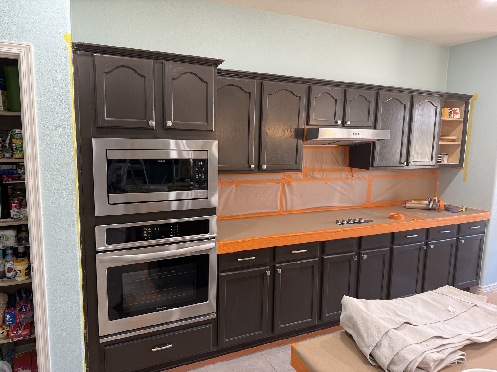 Kitchen masked and protected before cabinet refinishing